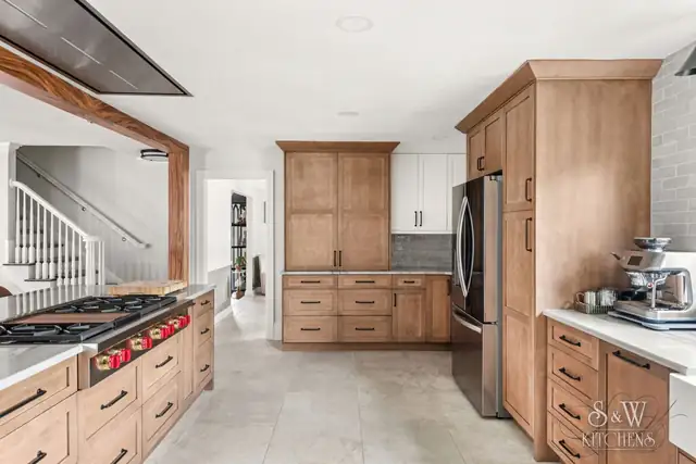 Clearwater kitchen with wood shaker cabinets, white quartz counters, pro-style gas range and stainless refrigerator